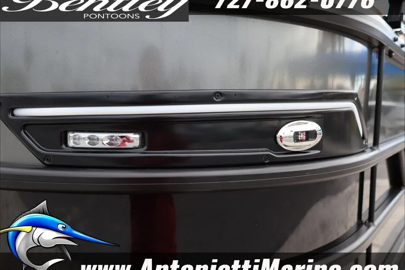 Slide: The Image of 2026 Bentley Pontoons Elite 223 Swingback Dual Capt, sleek black exterior detail. - 11