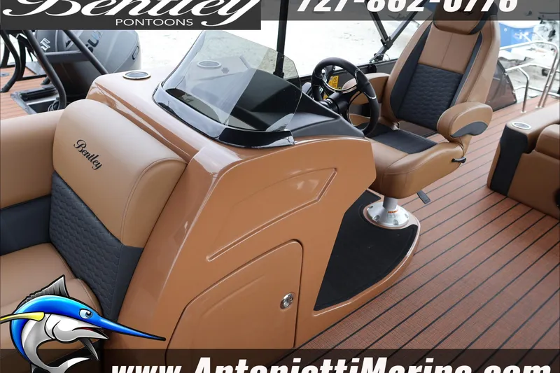 Slide: The Image of 2026 Bentley Pontoons Elite 223 Swingback Dual Captains, luxurious interior, brown and black seating. - 18