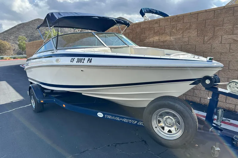 Slide: The Image of Interior of a 1997 Cobalt 190 boat, featuring steering wheel and seating. - 11
