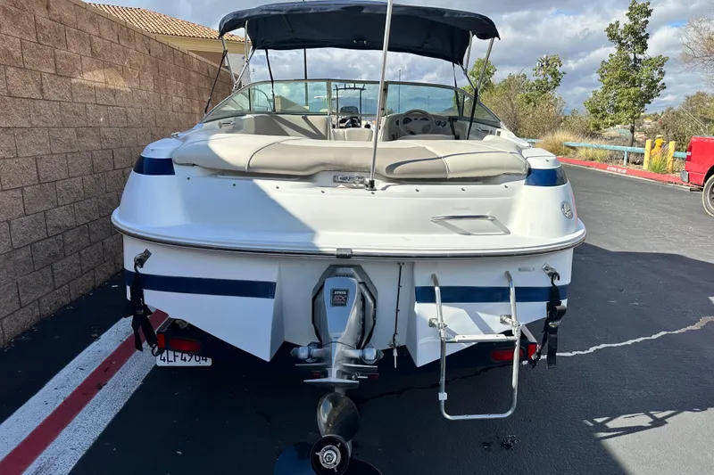 Slide: The Image of 1997 Cobalt 190 boat, rear view, parked on asphalt near brick wall. - 4