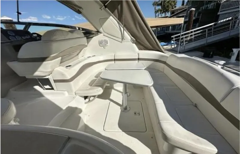 Slide: The Image of 2003 Formula 37 PC yacht interior with seating and table, docked under clear skies. - 10