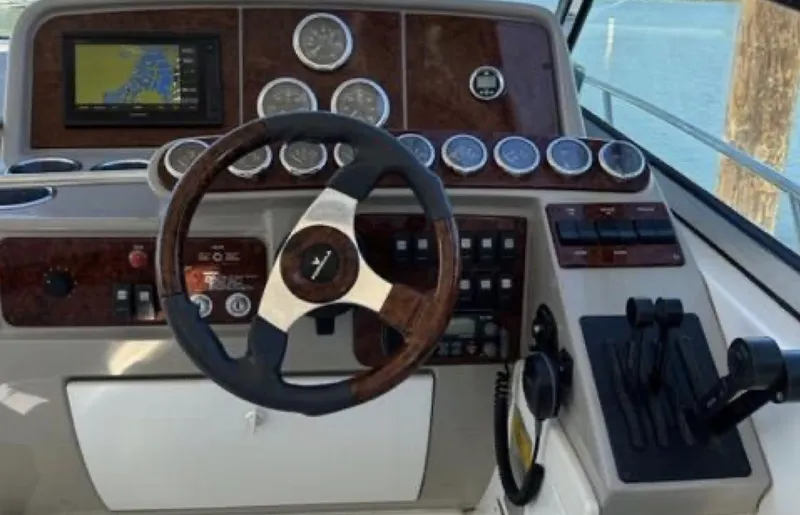 Slide: The Image of 2003 Formula 37 PC boat dashboard with steering wheel and navigation controls. - 14
