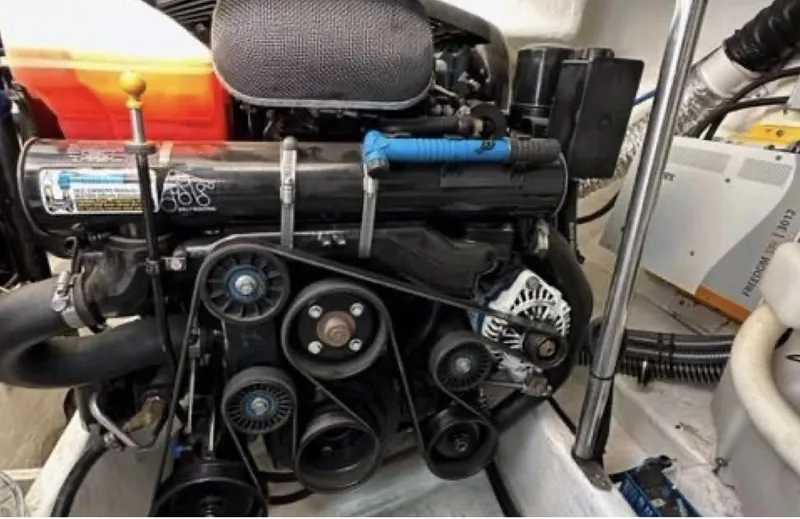 Slide: The Image of Engine compartment of a 2003 Formula 37 PC boat, showcasing belts and components. - 28