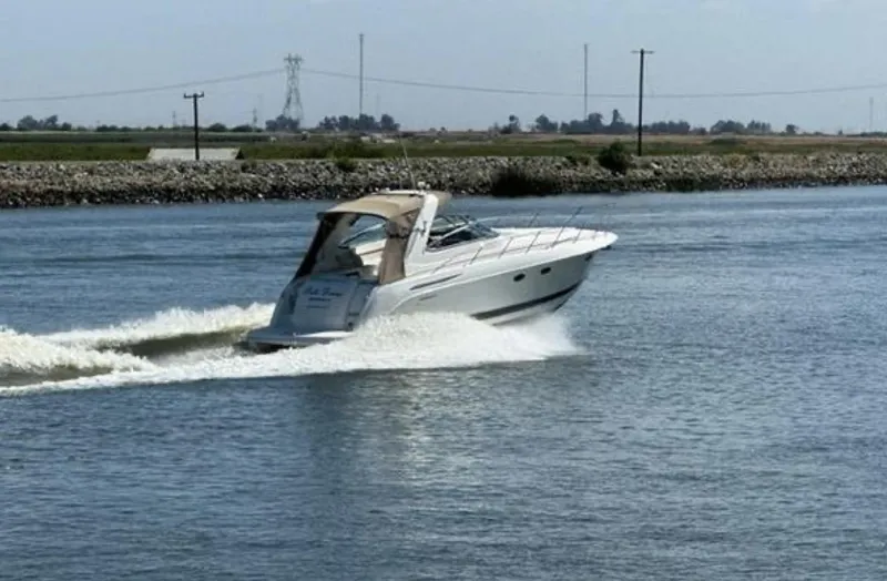 Slide: The Image of 2003 Formula 37 PC boat cruising on a calm river. - 34