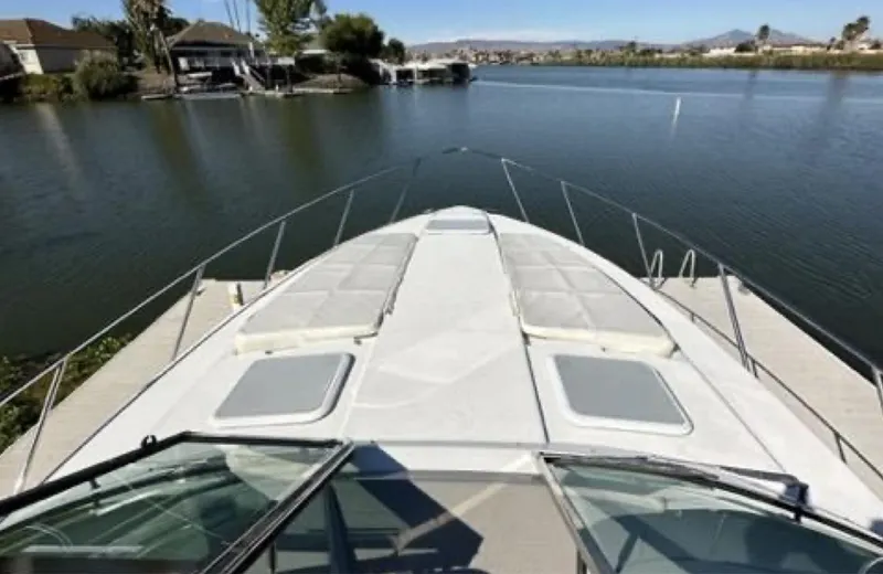 Slide: The Image of 2003 Formula 37 PC yacht on calm water, featuring spacious deck and scenic surroundings. - 8