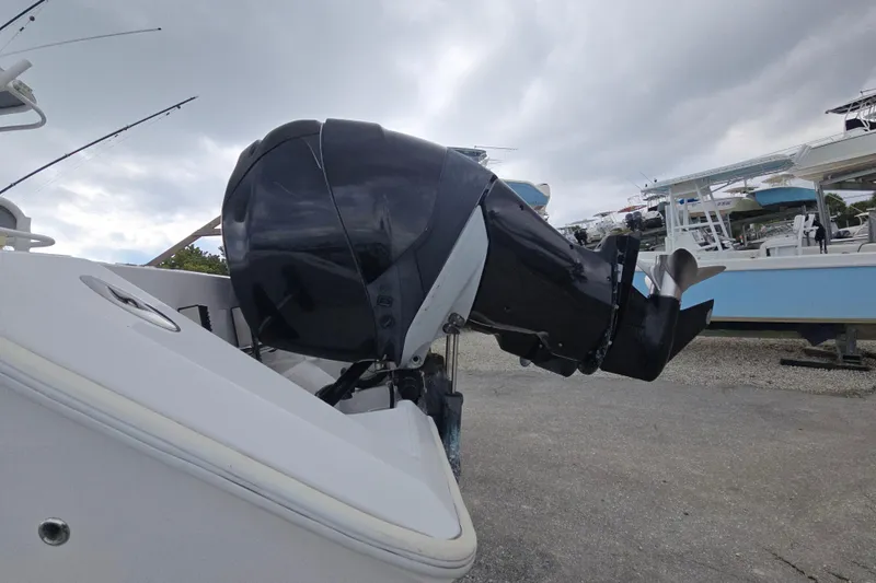 Slide: The Image of 2004 Jupiter boat with powerful outboard motor, docked under cloudy skies. - 3