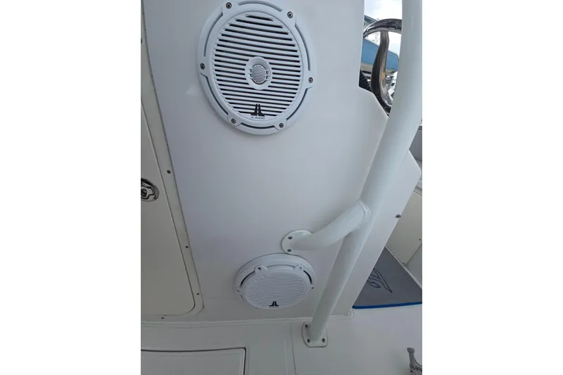 Slide: The Image of 2004 Jupiter boat interior with JL Audio speakers and white railing. - 5