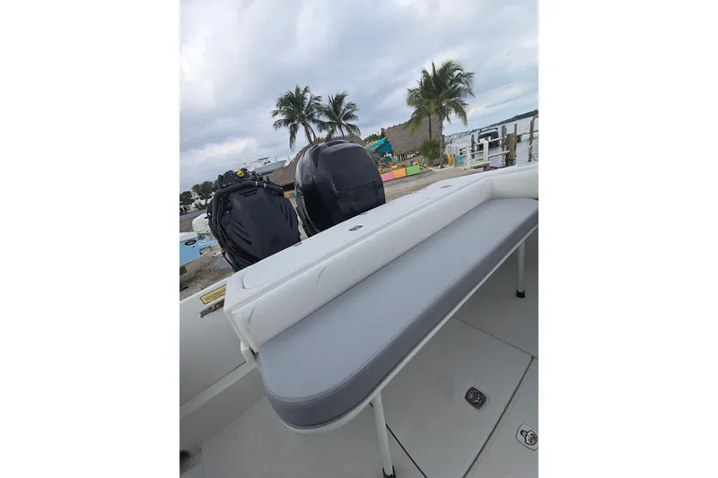 Slide: The Image of 2004 Jupiter boat interior with seating, dual engines, and tropical waterfront view. - 7