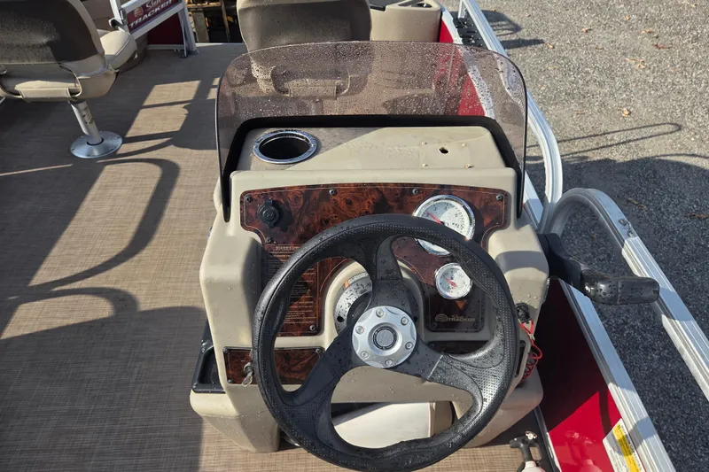 Slide: The Image of 2021 Sun Tracker Bass Buggy 18 DLX steering console with gauges and cup holder. - 10