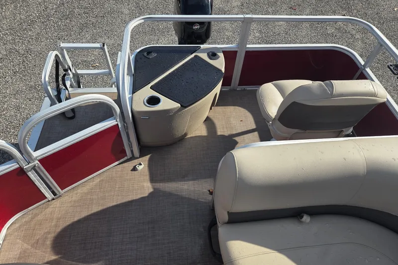 Slide: The Image of 2021 Sun Tracker Bass Buggy 18 DLX interior with seating and helm, featuring beige upholstery. - 13