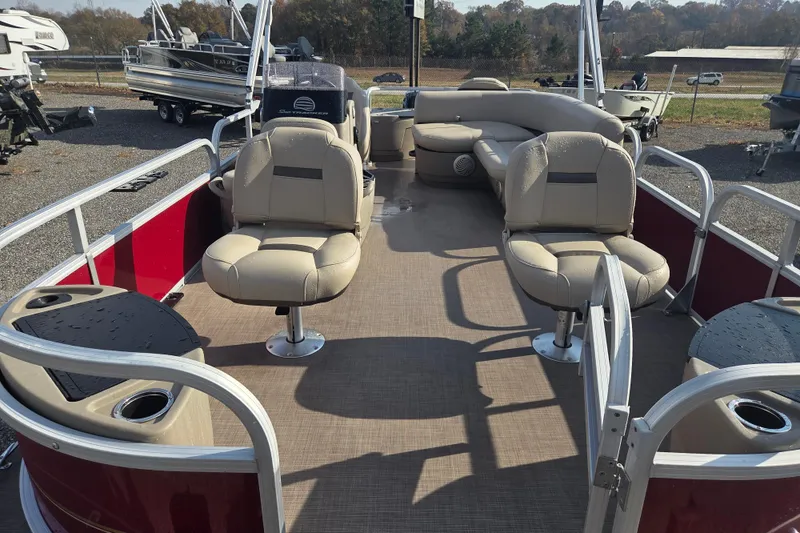 Slide: The Image of 2021 Sun Tracker Bass Buggy 18 DLX pontoon boat with beige seating and red exterior. - 14