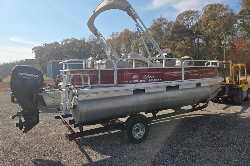 Slide: The Image of 2021 Sun Tracker Bass Buggy 18 DLX pontoon boat on trailer, outdoors. - 3