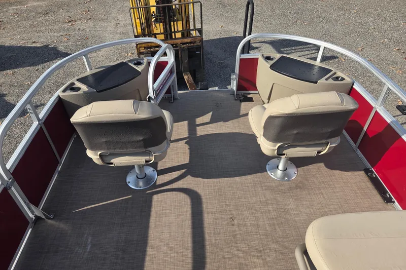 Slide: The Image of 2021 Sun Tracker Bass Buggy 18 DLX pontoon boat interior with beige seats and red panels. - 9
