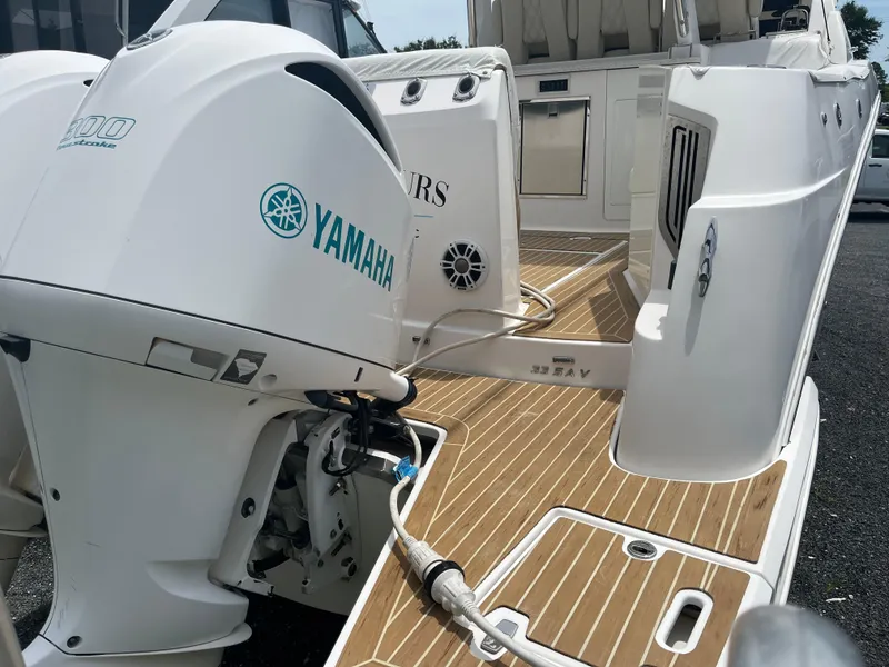 Slide: The Image of 2019 Regal 33 SAV boat with Yamaha outboard engine, teak deck, and spacious seating area. - 13