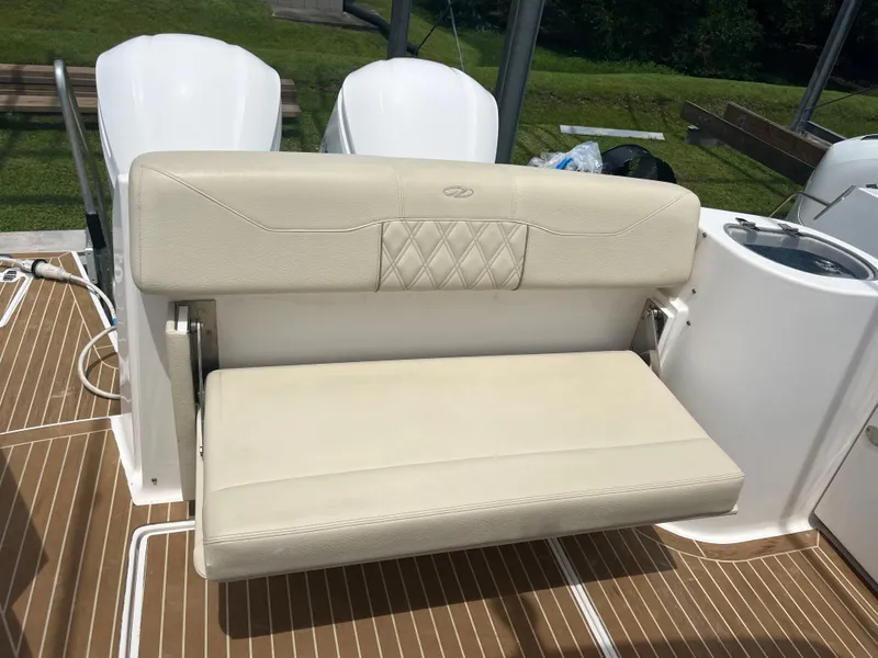 Slide: The Image of 2019 Regal 33 SAV boat seat with white upholstery and teak flooring. - 16