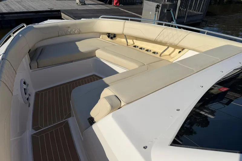 Slide: The Image of 2019 Regal 33 SAV boat with spacious beige seating and cup holders. - 36