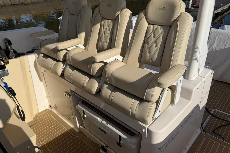 Slide: The Image of 2019 Regal 33 SAV boat interior with beige cushioned seats and armrests. - 37