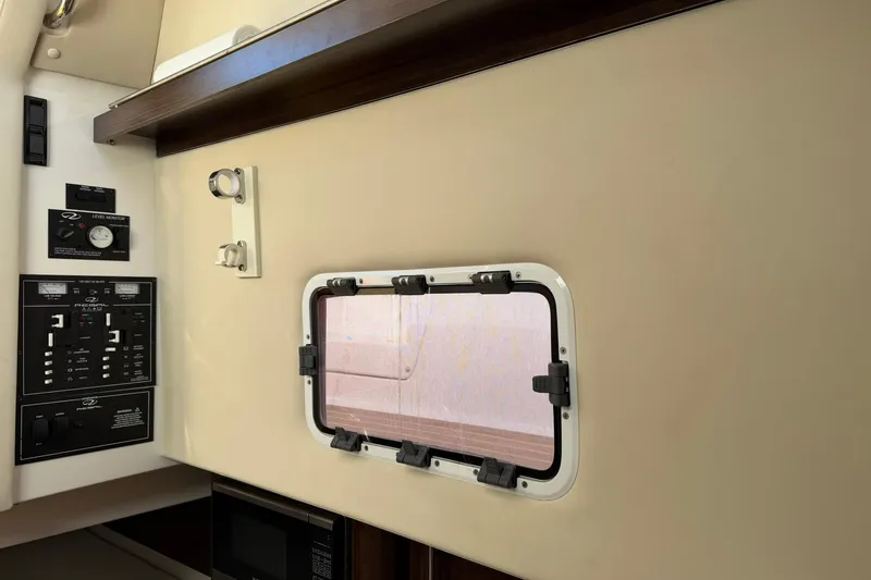 Slide: The Image of Interior view of 2019 Regal 33 SAV boat with control panels and window. - 44