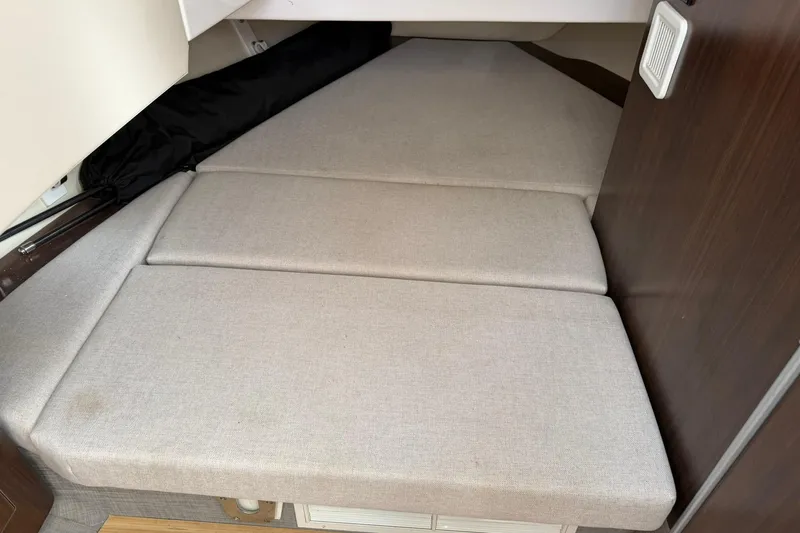 Slide: The Image of 2019 Regal 33 SAV boat interior cabin with beige cushions. - 46