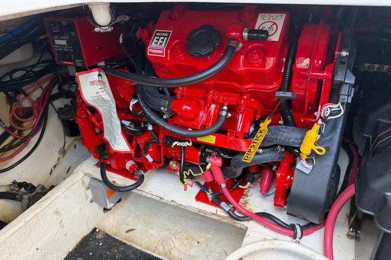 Slide: The Image of Red engine of a 2019 Regal 33 SAV boat with visible wiring and components. - 49