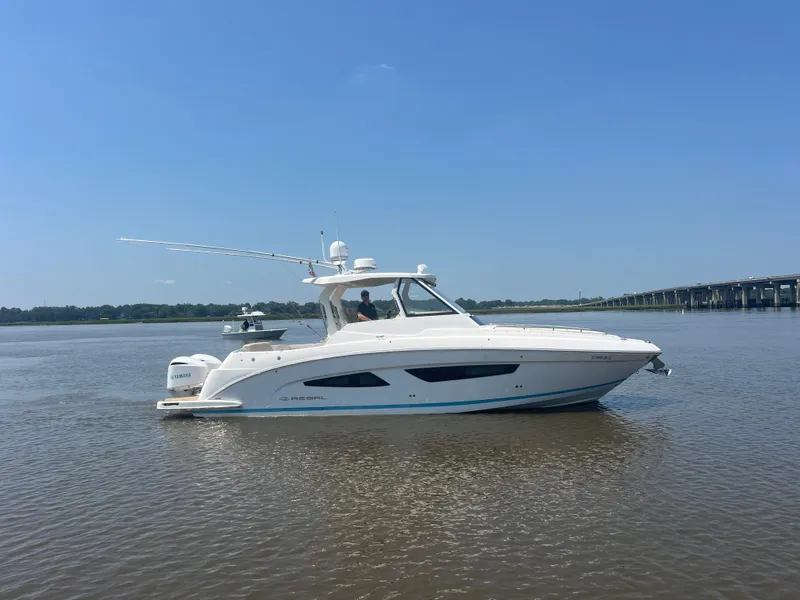 Slide: The Image of 2019 Regal 33 SAV boat on calm water with clear blue sky background. - 5