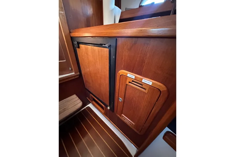 Slide: The Image of Wooden interior of 2008 Wasque 26 boat, featuring storage compartments. - 10