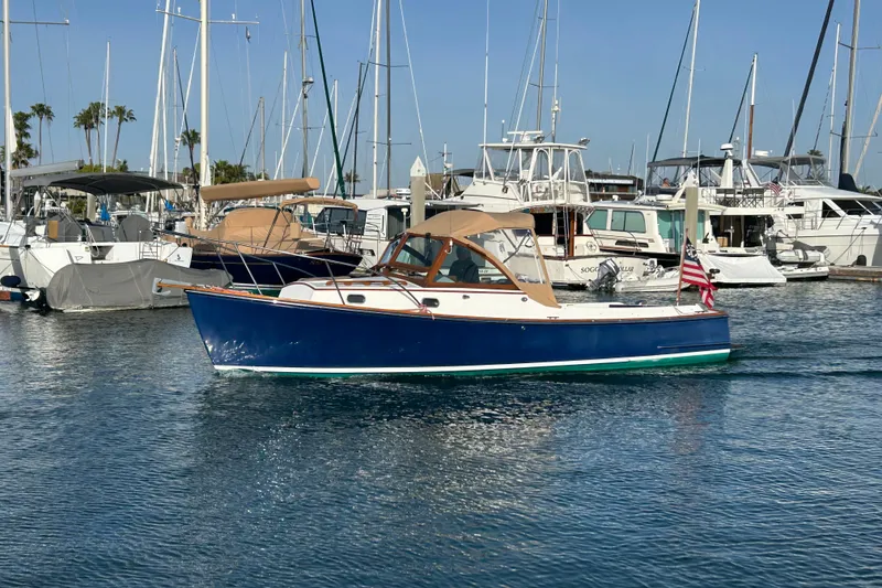Slide: The Image of 2008 Wasque 26 boat in marina, surrounded by other yachts and sailboats. - 17