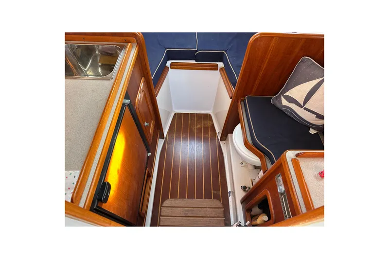 Slide: The Image of Interior of 2008 Wasque 26 boat with wooden flooring and nautical-themed decor. - 25