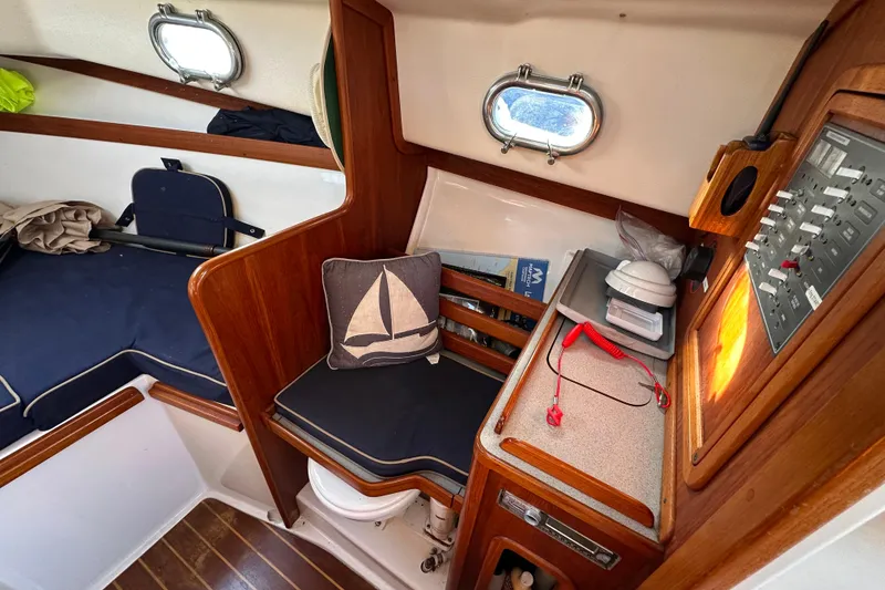 Slide: The Image of Interior of a 2008 Wasque 26 yacht with wooden furnishings. - 26