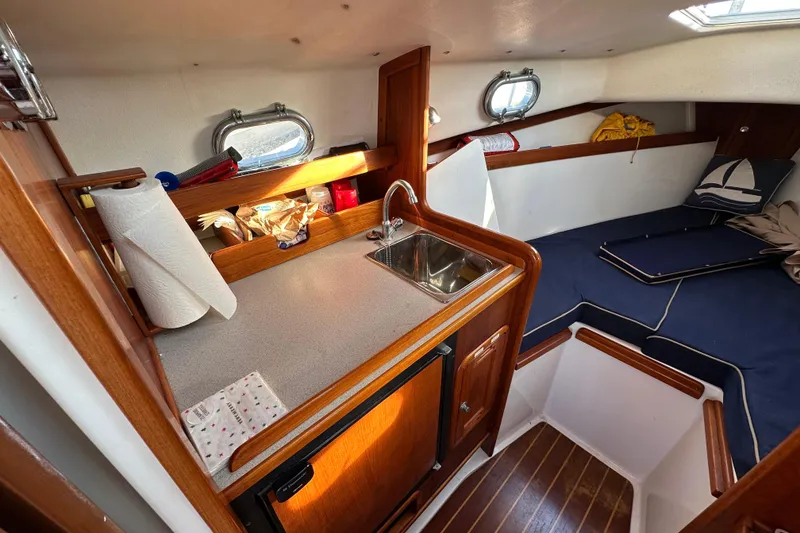 Slide: The Image of Interior of a 2008 Wasque 26 yacht with kitchenette and sleeping area. - 27