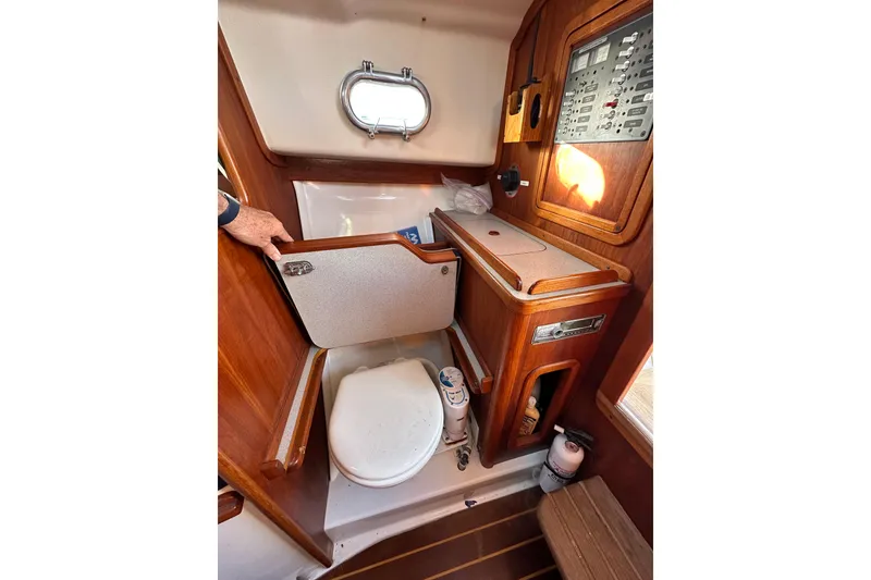 Slide: The Image of Interior of 2008 Wasque 26 boat featuring compact wooden bathroom setup. - 31