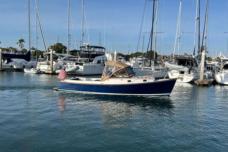 Slide: The Image of 2008 Wasque 26 boat docked in a marina with other sailboats. - 36