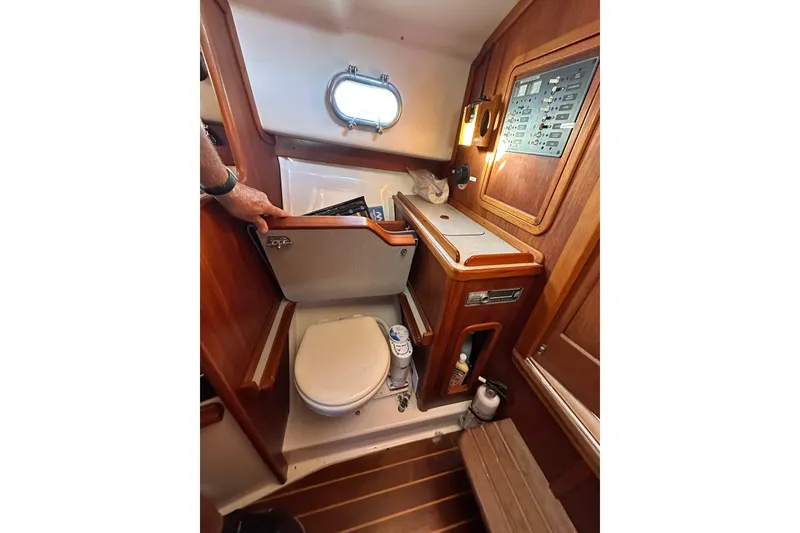 Slide: The Image of 2008 Wasque 26 boat interior with compact bathroom and wooden cabinetry. - 9