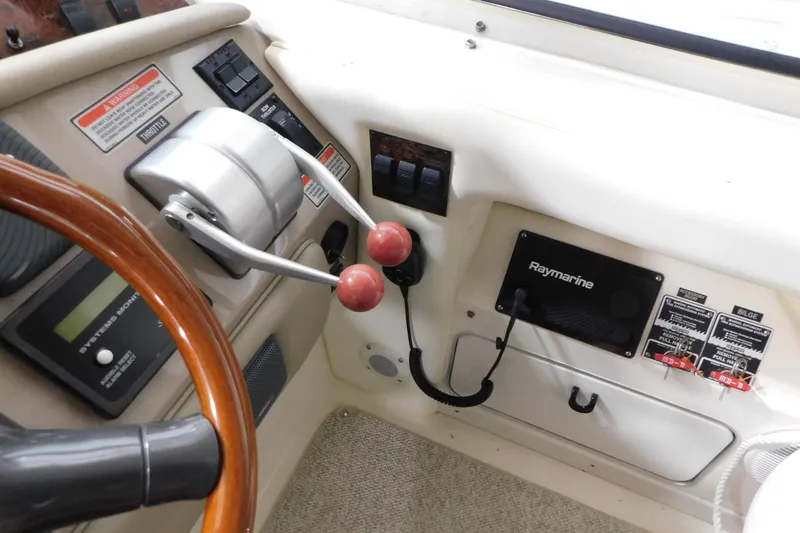 Slide: The Image of 1999 Sea Ray 500 Sundancer helm with Raymarine electronics and dual throttle controls. - 15