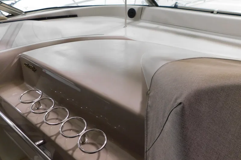 Slide: The Image of 1999 Sea Ray 500 Sundancer dashboard with cup holders and sleek design. - 16