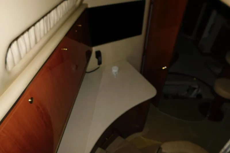 Slide: The Image of 1999 Sea Ray 500 Sundancer interior with wooden cabinetry and countertop. - 18