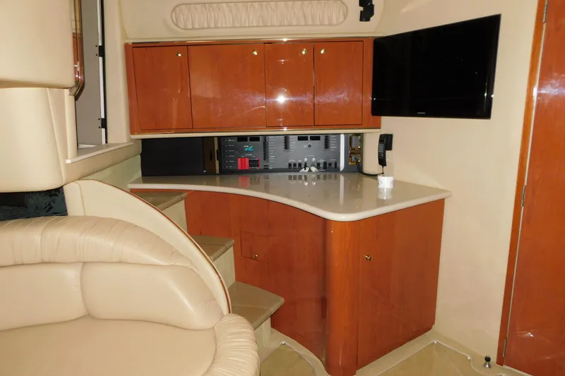 Slide: The Image of 1999 Sea Ray 500 Sundancer interior with wooden cabinets and modern amenities. - 21