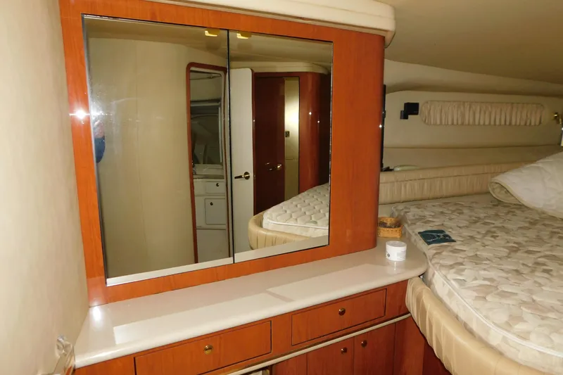 Slide: The Image of Interior of 1999 Sea Ray 500 Sundancer yacht with mirrored cabinet and bed. - 26