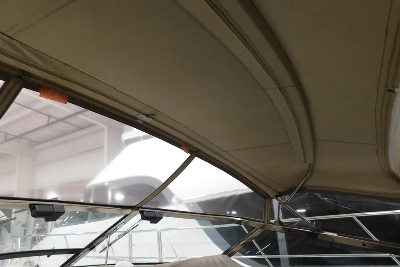 Slide: The Image of Interior view of 1999 Sea Ray 500 Sundancer boat with beige canopy. - 34