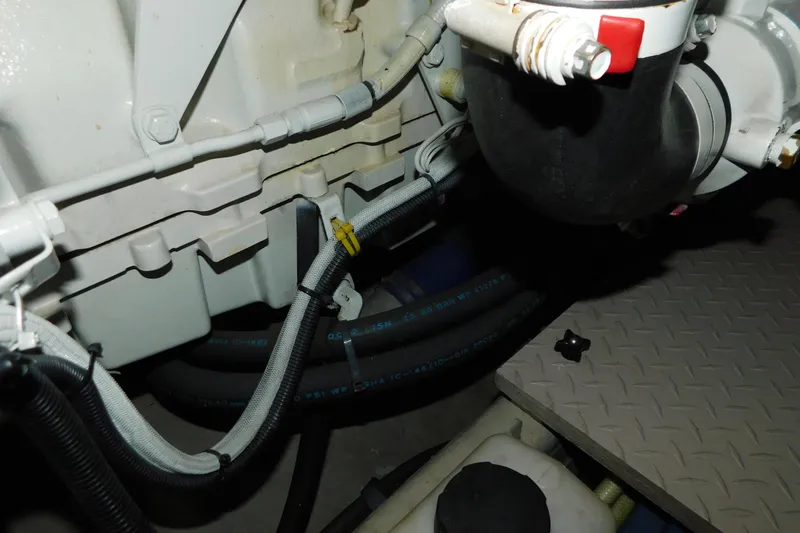 Slide: The Image of Engine compartment of a 1999 Sea Ray 500 Sundancer with visible hoses and components. - 46