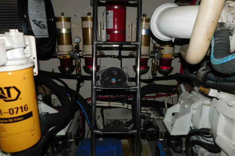 Slide: The Image of Engine room of 1999 Sea Ray 500 Sundancer with filters and piping visible. - 47