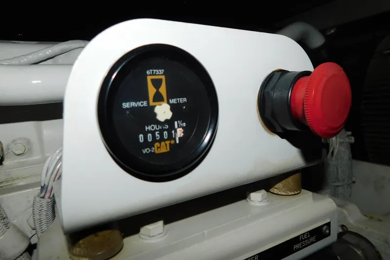 Slide: The Image of Service meter and red button on 1999 Sea Ray 500 Sundancer boat. - 48