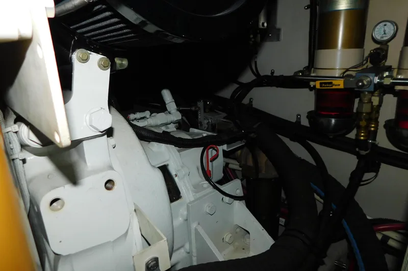 Slide: The Image of Engine compartment of a 1999 Sea Ray 500 Sundancer, showcasing mechanical components and filters. - 50