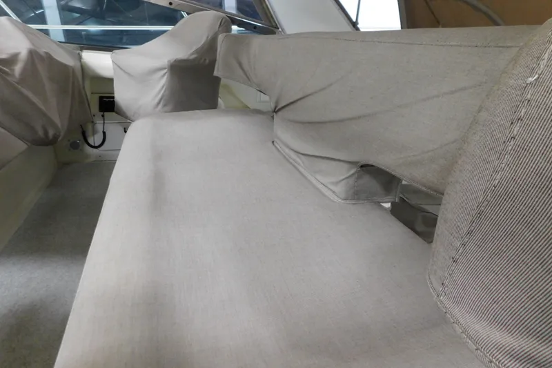Slide: The Image of Interior seating of 1999 Sea Ray 500 Sundancer, covered in protective fabric. - 9