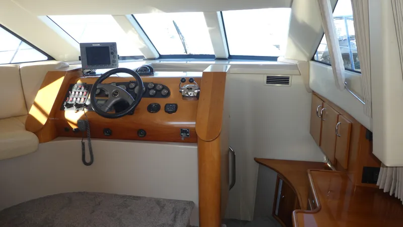 Slide: The Image of 2005 Carver 38 Super Sport yacht interior with helm and navigation equipment. - 11
