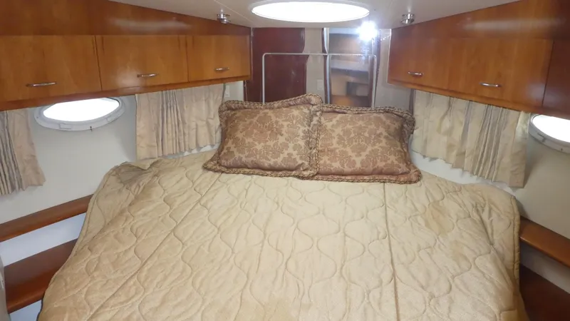Slide: The Image of Luxurious cabin interior of 2005 Carver 38 Super Sport yacht with cozy bedding. - 15