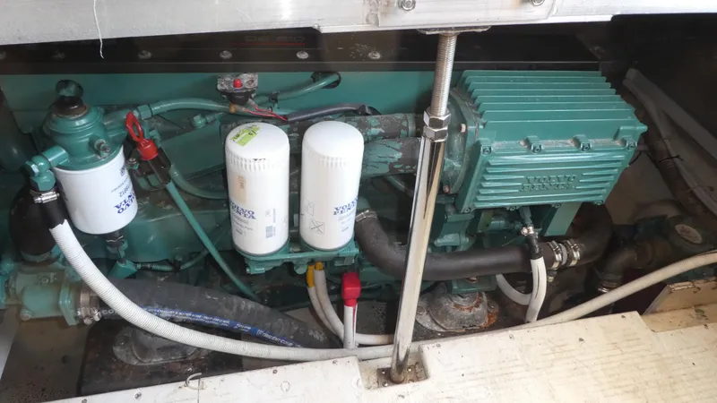 Slide: The Image of Engine compartment of a 2005 Carver 38 Super Sport boat, featuring filters and hoses. - 35