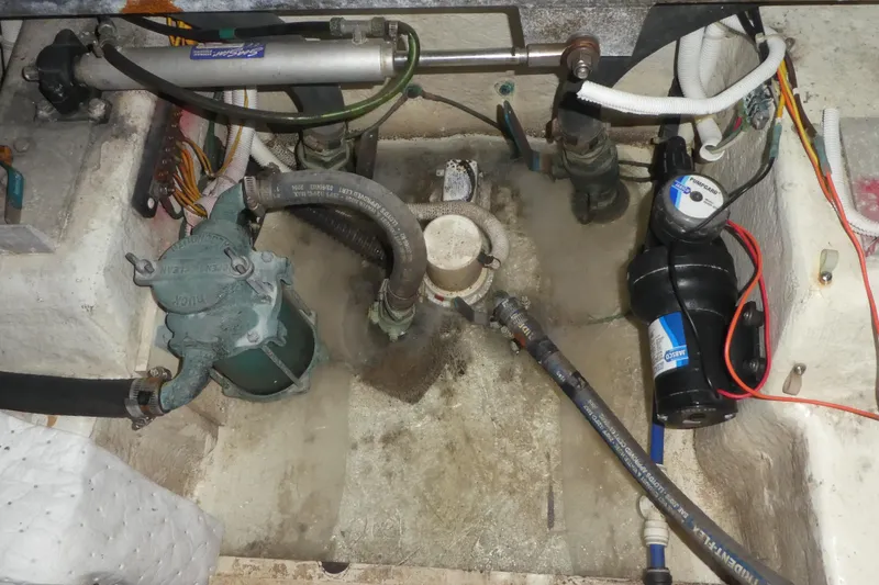 Slide: The Image of Engine compartment of a 2005 Carver 38 Super Sport boat, showing various mechanical components. - 38