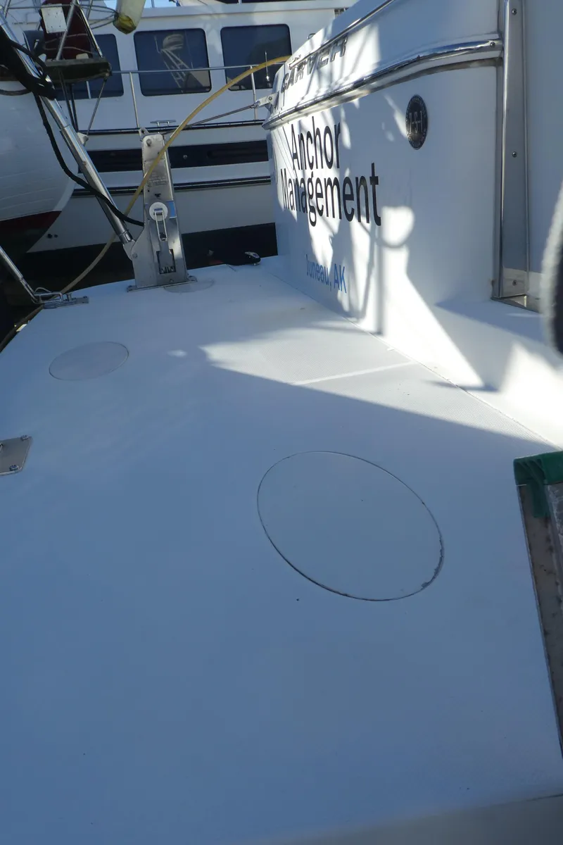 Slide: The Image of 2005 Carver 38 Super Sport boat deck with visible name, docked in marina. - 40