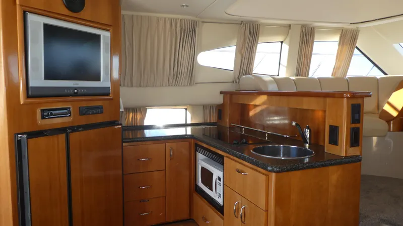 Slide: The Image of Luxurious interior of 2005 Carver 38 Super Sport yacht with modern kitchen amenities. - 7